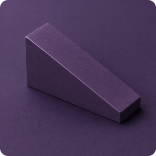 Purple triangular prism block on a matching purple surface.